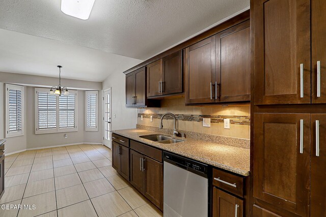 14182 John Scagno, El Paso, TX 79938 - kitchen featuring baseboards, a sink, stainless steel dishwasher, and dark brown cabinets
