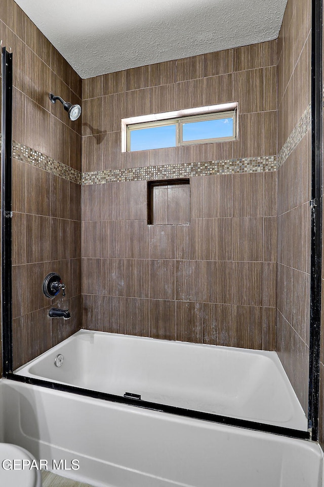 14182 John Scagno, El Paso, TX 79938 - full bath with a wealth of natural light, shower / bathing tub combination, and a textured ceiling