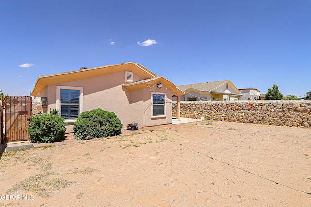 14182 John Scagno, El Paso, TX 79938 - rear view of house featuring a gate, fence, and stucco siding