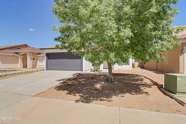 view of front of home featuring driveway, stucco siding, and a garage