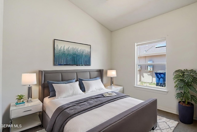 bedroom featuring baseboards, carpet flooring, and vaulted ceiling