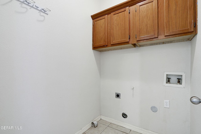 clothes washing area with cabinet space, hookup for an electric dryer, gas dryer hookup, baseboards, and hookup for a washing machine