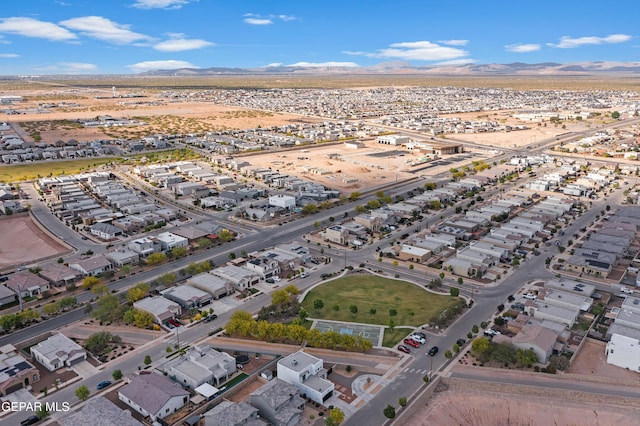 aerial overview of property's location featuring a mountain backdrop and nearby suburban area