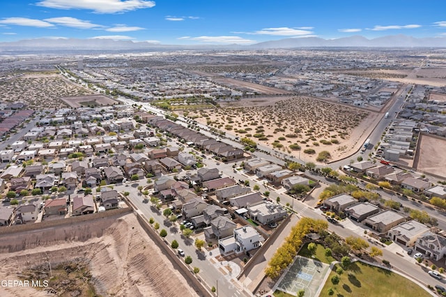 view of property location featuring mountains and nearby suburban area