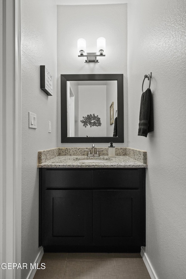 bathroom featuring baseboards and vanity