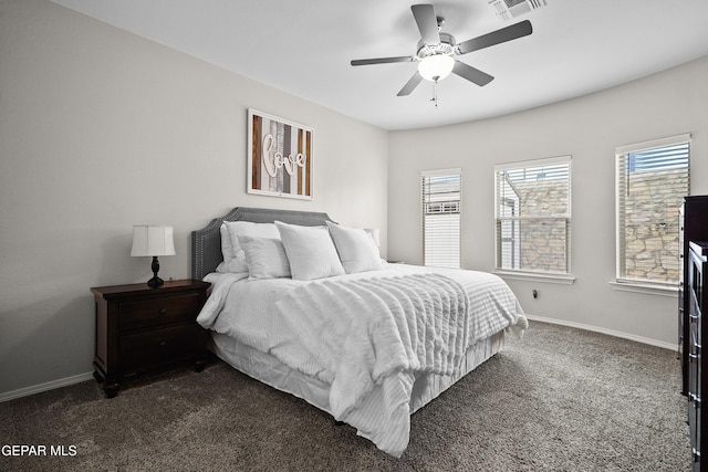 bedroom featuring dark carpet, baseboards, and ceiling fan