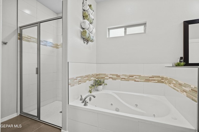 full bathroom with a stall shower and a tub with jets