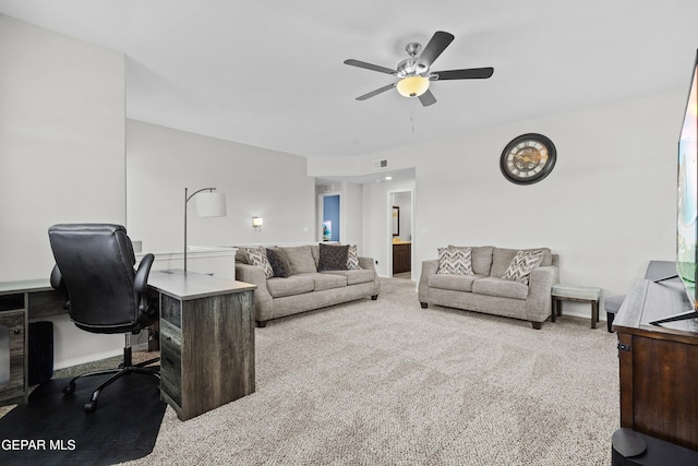 carpeted living area featuring an office area, a ceiling fan, and baseboards
