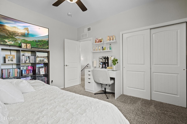 carpeted bedroom featuring a closet, a desk, and a ceiling fan