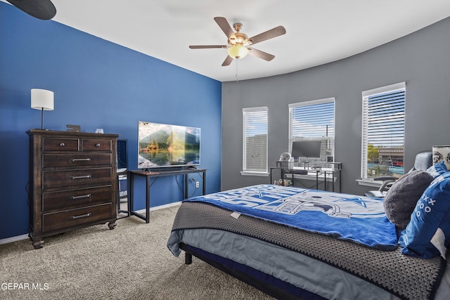 bedroom with carpet flooring, an office area, baseboards, and ceiling fan