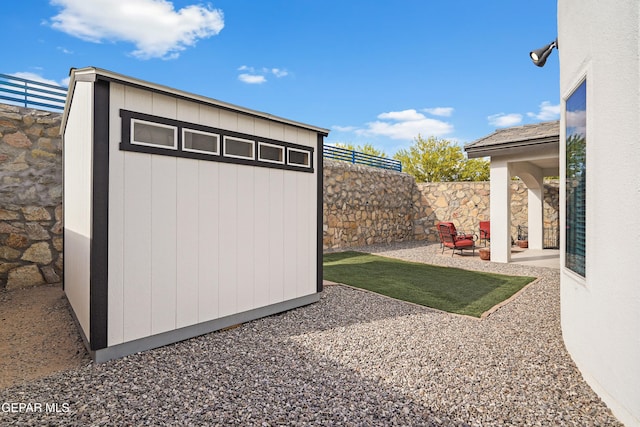 view of shed featuring a fenced backyard