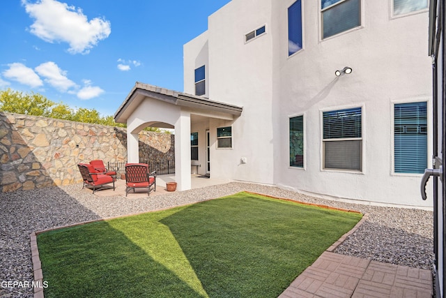 back of property featuring stucco siding and a patio area