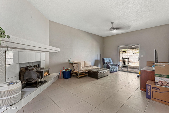 living area with a textured ceiling and light tile patterned flooring