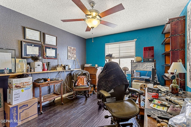 office space featuring a ceiling fan, hardwood / wood-style floors, a textured ceiling, and a textured wall