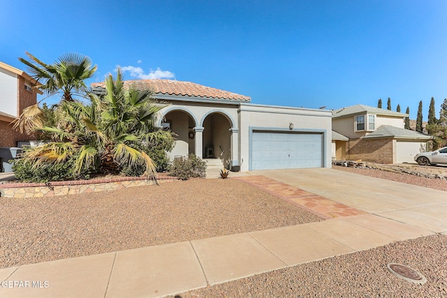 mediterranean / spanish-style house with driveway, stucco siding, a garage, and a tile roof