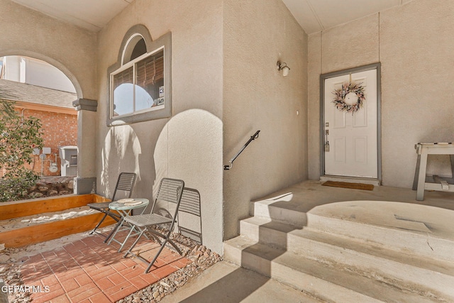entrance to property featuring stucco siding