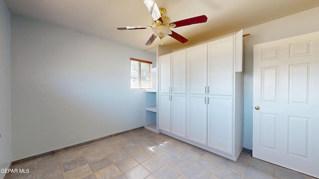 unfurnished bedroom featuring a closet, baseboards, and a ceiling fan