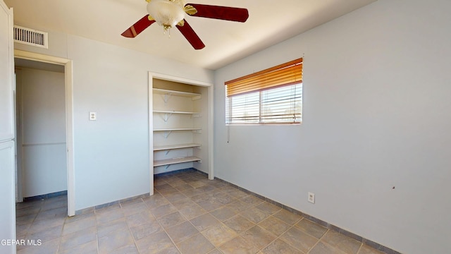unfurnished bedroom featuring a closet, ceiling fan, and baseboards