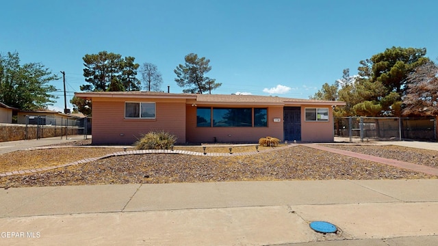ranch-style house with fence