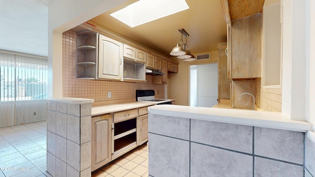 kitchen with under cabinet range hood, white electric range oven, open shelves, a skylight, and light tile patterned floors
