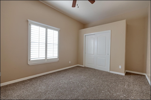 unfurnished bedroom featuring carpet, a closet, and ceiling fan