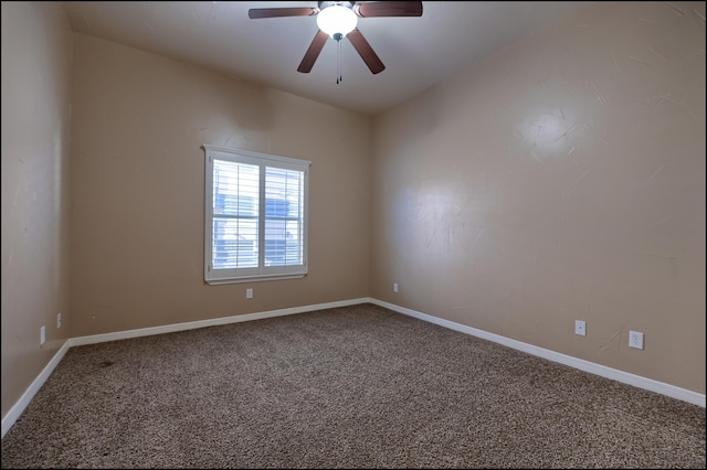 carpeted empty room featuring a ceiling fan and baseboards