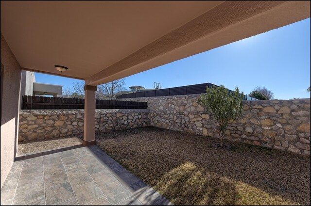 fenced backyard with a patio area