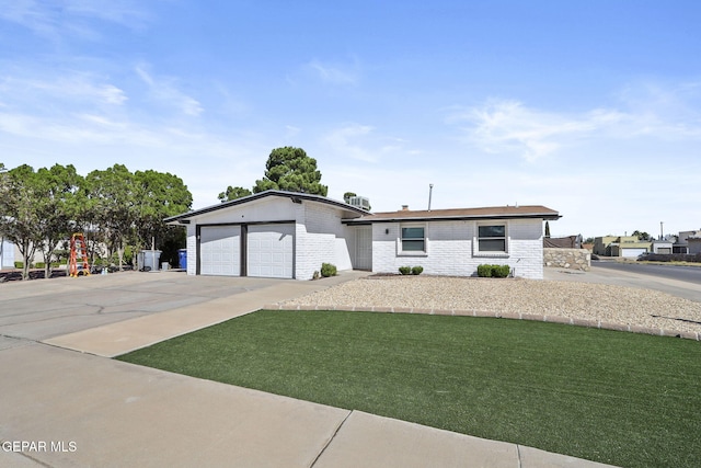 single story home featuring a garage, brick siding, concrete driveway, and a front yard