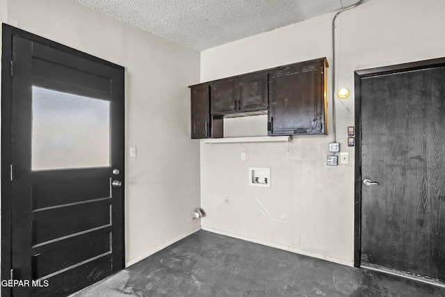 clothes washing area featuring hookup for a washing machine and a textured ceiling