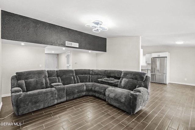 living area featuring dark wood-style flooring, baseboards, and recessed lighting