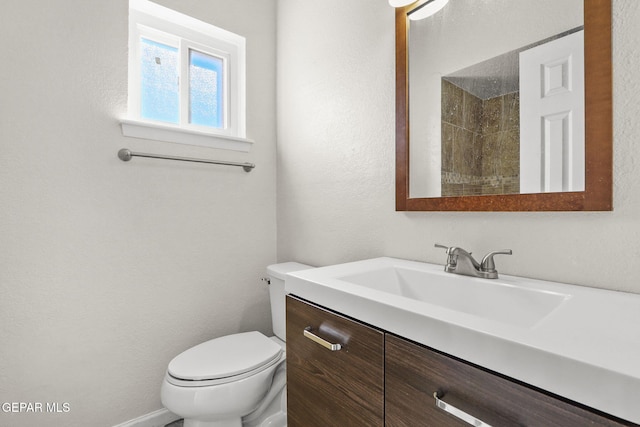 bathroom featuring toilet and vanity