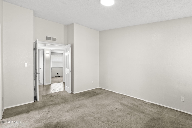 unfurnished bedroom featuring carpet flooring, baseboards, and a textured ceiling