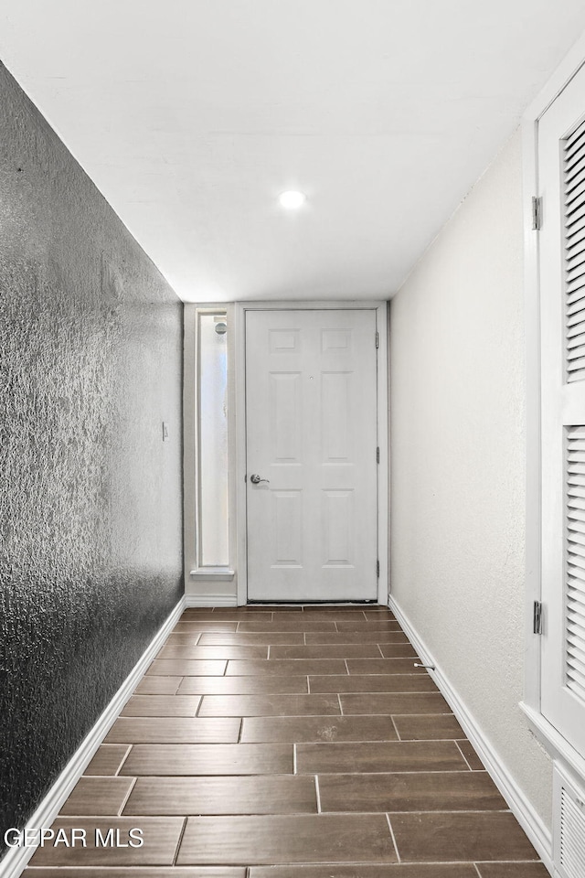 entrance foyer with wood finish floors and baseboards