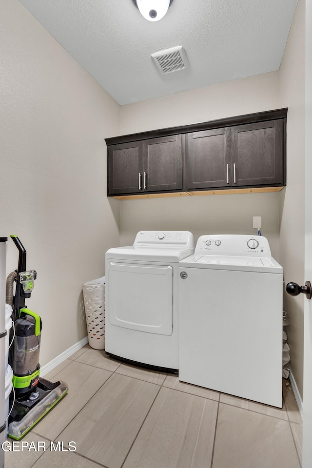laundry room featuring cabinet space, independent washer and dryer, and baseboards