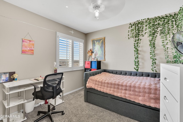 carpeted bedroom with a desk and baseboards