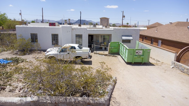 rear view of property featuring stucco siding