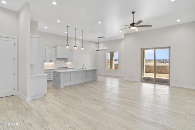 820 Acton St, Horizon City, TX 79928 - kitchen with open floor plan, recessed lighting, light countertops, baseboards, and an island with sink