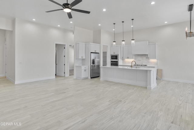 820 Acton St, Horizon City, TX 79928 - kitchen featuring appliances with stainless steel finishes, open floor plan, light countertops, tasteful backsplash, and a ceiling fan