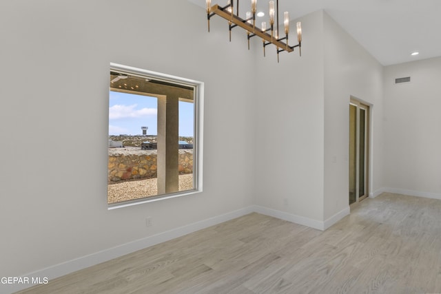 820 Acton St, Horizon City, TX 79928 - spare room with wood finished floors, a chandelier, baseboards, recessed lighting, and a high ceiling
