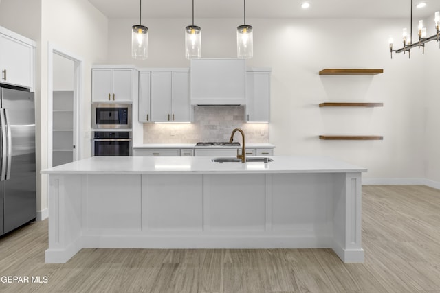 820 Acton St, Horizon City, TX 79928 - kitchen featuring appliances with stainless steel finishes, a sink, light wood-style flooring, light countertops, and recessed lighting
