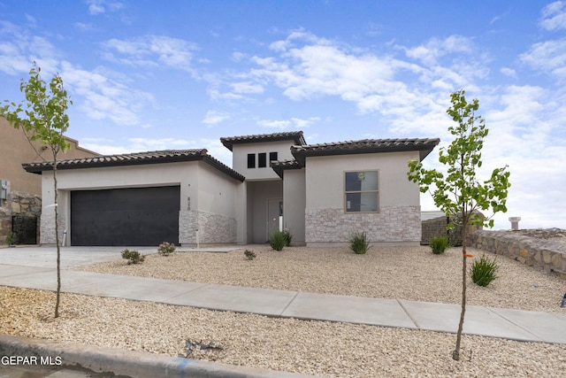 820 Acton St, Horizon City, TX 79928 - mediterranean / spanish home featuring stucco siding, a tile roof, concrete driveway, an attached garage, and stone siding