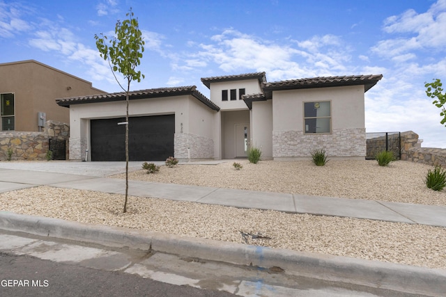 820 Acton St, Horizon City, TX 79928 - mediterranean / spanish house with stucco siding, a tiled roof, driveway, and an attached garage