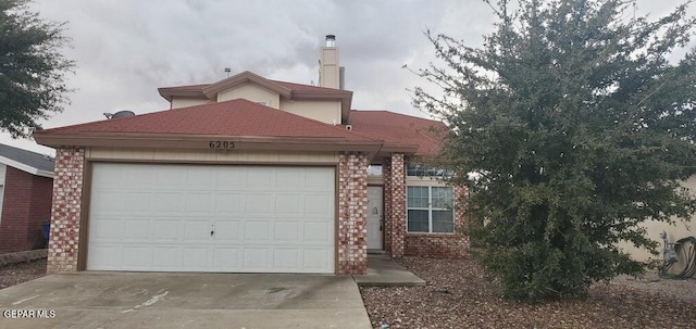 6205 Alina Baltazar Dr, El Paso, TX 79932 - view of front of house featuring brick siding, driveway, and an attached garage