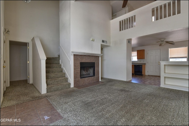 6205 Alina Baltazar Dr, El Paso, TX 79932 - unfurnished living room with carpet, a high ceiling, ceiling fan, a fireplace, and stairs