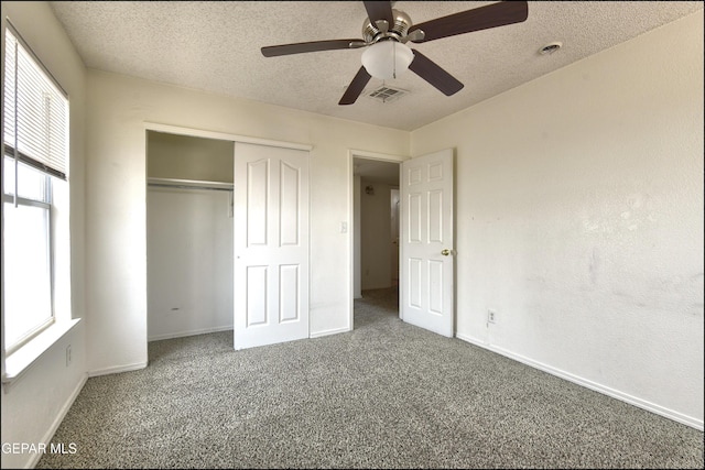 6205 Alina Baltazar Dr, El Paso, TX 79932 - unfurnished bedroom featuring carpet flooring, multiple windows, a textured ceiling, and a closet