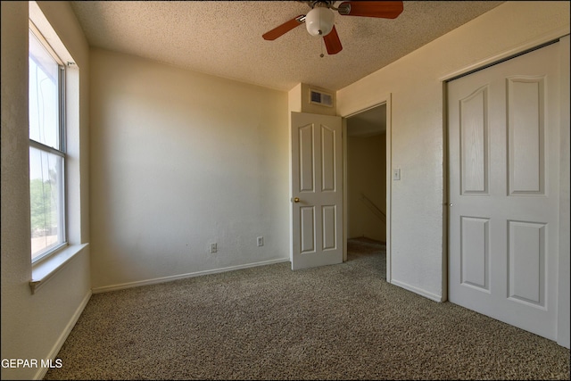 6205 Alina Baltazar Dr, El Paso, TX 79932 - unfurnished bedroom with carpet, a textured ceiling, and a ceiling fan