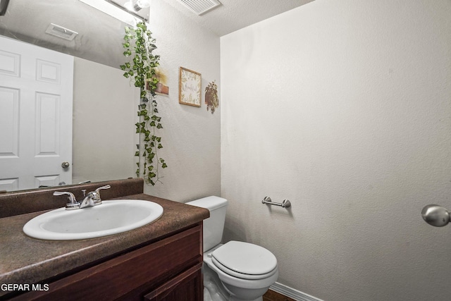 half bathroom with toilet and vanity