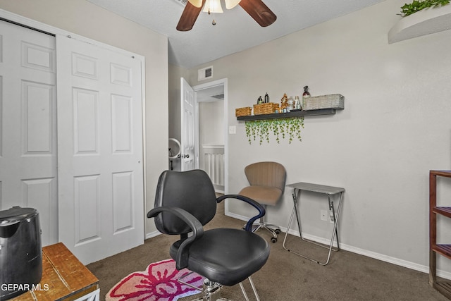 sitting room with carpet, a ceiling fan, and baseboards