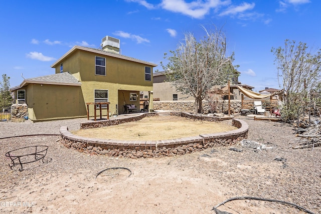 rear view of property featuring a patio, cooling unit, and stucco siding