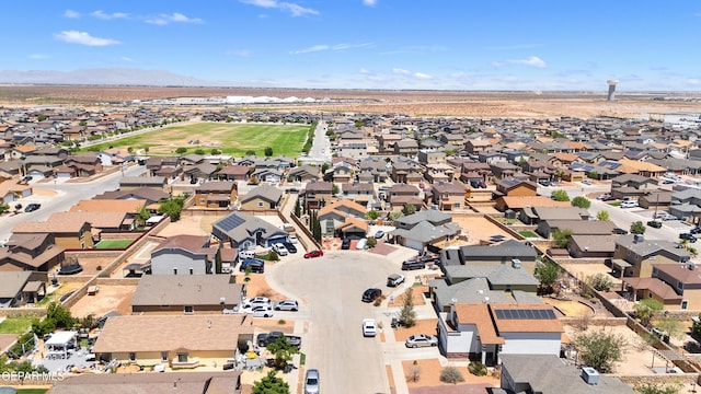 aerial view of property and surrounding area with nearby suburban area and a mountainous background